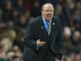 Rafael Benitez squats and barks during the Premier League game between Manchester United and Newcastle United on November 18, 2017