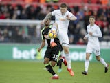 Alfie Mawson and Jordon Ibe in action during the Premier League game between Swansea City and Bournemouth on November 25, 2017