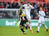 Alfie Mawson and Jordon Ibe in action during the Premier League game between Swansea City and Bournemouth on November 25, 2017