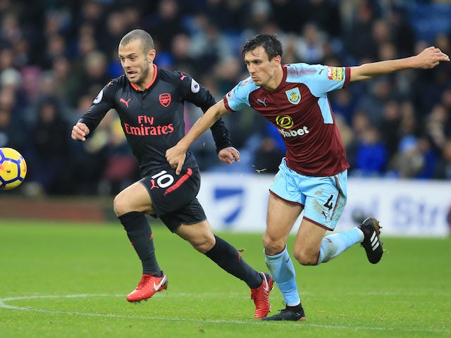 Jack Wilshere and Jack Cork in action during the Premier League game between Burnley and Arsenal on November 26, 2017