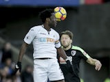Wilfried Bony and Harry Arter in action during the Premier League game between Swansea City and Bournemouth on November 25, 2017