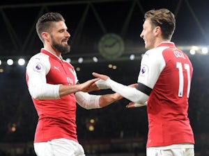 Olivier Giroud celebrates with Mesut Ozil during the Premier League game between Arsenal and Huddersfield Town on November 29, 2017