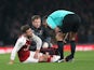 Shkodran Mustafi goes down injured during the Premier League game between Arsenal and Manchester United on December 2, 2017