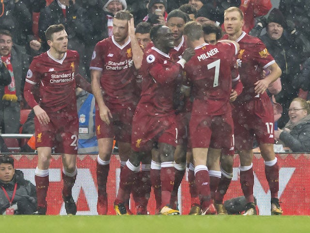 Mohamed Salah celebrates with teammates after scoring the opener during the Premier League game between Liverpool and Everton on December 10, 2017