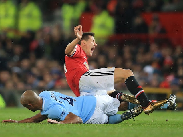 Vincent Kompany fouls Ander Herrera during the Premier League game between Manchester United and Manchester City on December 10, 2017