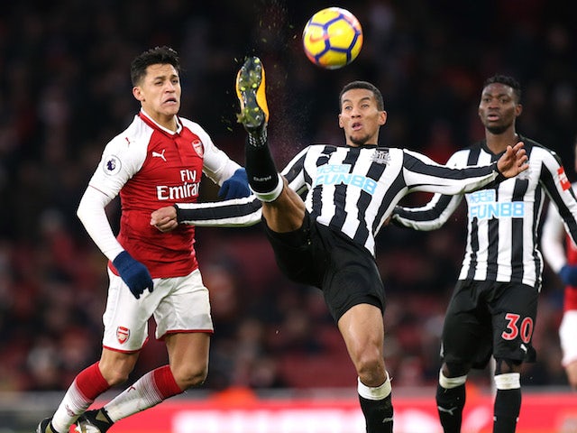 Alexis Sanchez and Isaac Hayden in action during the Premier League game between Arsenal and Newcastle United on December 16, 2017