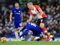 Eden Hazard goes down under Oriol Romeu during the Premier League game between Chelsea and Southampton on December 16, 2017