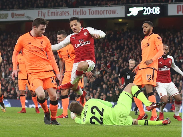 Alexis Sanchez and Simon Mignolet in action during the Premier League game between Arsenal and Liverpool on December 22, 2017