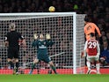 Philippe Coutinho heads in past Petr Cech during the Premier League game between Arsenal and Liverpool on December 22, 2017