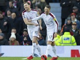 Ashley Barnes celebrates with Johann Berg Gudmundsson during the Premier League game between Manchester United and Burnley on December 26, 2017