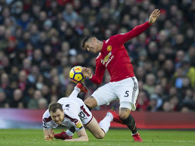 Marcos Rojo and Ashley Barnes in action during the Premier League game between Manchester United and Burnley on December 26, 2017