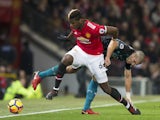 Paul Pogba and Oriol Romeu in action during the Premier League game between Manchester United and Southampton on December 30, 2017