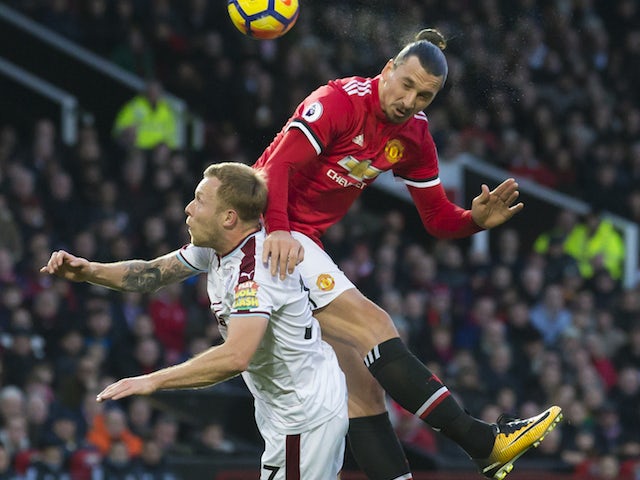 Zlatan Ibrahimovic tussles with Scott Arfield during the Premier League game between Manchester United and Burnley on December 26, 2017