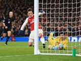 Thibaut Courtois thwarts Mesut Ozil after Alexis Sanchez's rebound during the Premier League game between Arsenal and Chelsea on January 3, 2018