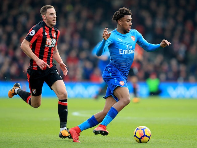 Dan Gosling and Alex Iwobi in action during the Premier League game between Bournemouth and Arsenal on January 14, 2018