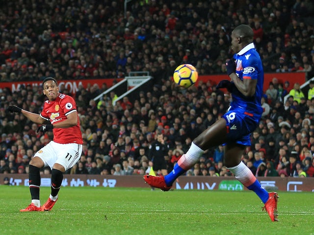 Anthony Martial fires past Kurt Zouma for the second during the Premier League game between Manchester United and Stoke City on January 15, 2018