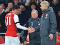 Mesut Ozil shakes Arsene Wenger's hand during the Premier League game between Arsenal and Crystal Palace on January 20, 2018