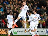 Alfie Mawson celebrates scoring during the Premier League game between Swansea City and Liverpool on January 22, 2018