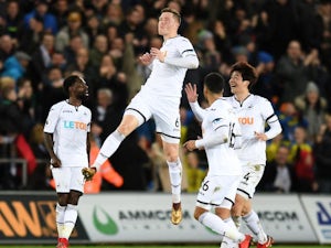 Alfie Mawson celebrates scoring during the Premier League game between Swansea City and Liverpool on January 22, 2018