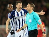 West Bromwich Albion defender Jonny Evans complains to referee Craig Pawson over a VAR decision during his side's FA Cup fourth round clash with Liverpool at Anfield on January 27, 2018