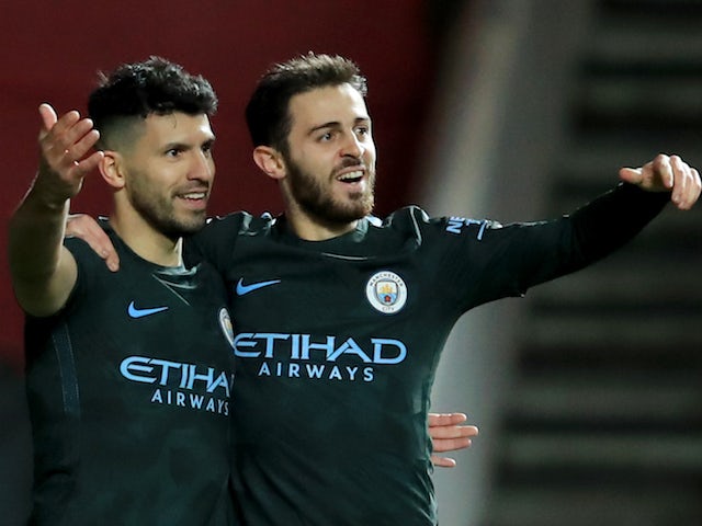 Sergio Aguero celebrates with Bernardo Silva after scoring during the EFL Cup game between Bristol City and Manchester City on January 23, 2018