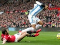 Juan Mata tackles Collin Quaner in the Premier League match between Manchester United and Huddersfield Town on February 3, 2018