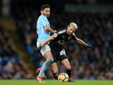 Ilkay Gundogan tussles with Riyad Mahrez during the Premier League game between Manchester City and Leicester City on February 10, 2018