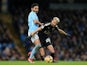 Ilkay Gundogan tussles with Riyad Mahrez during the Premier League game between Manchester City and Leicester City on February 10, 2018