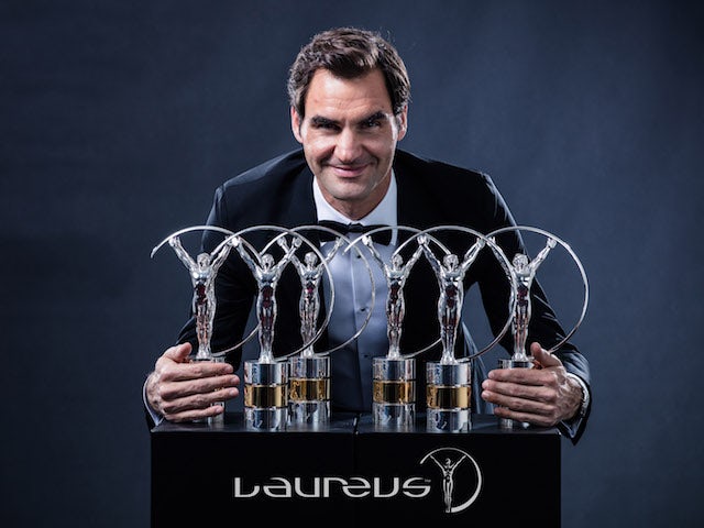Roger Federer poses with his collection of Laureus Awards in February 2018