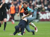 Mark Noble destroys a pitch invader during the Premier League game between West Ham United and Burnley on March 10, 2018