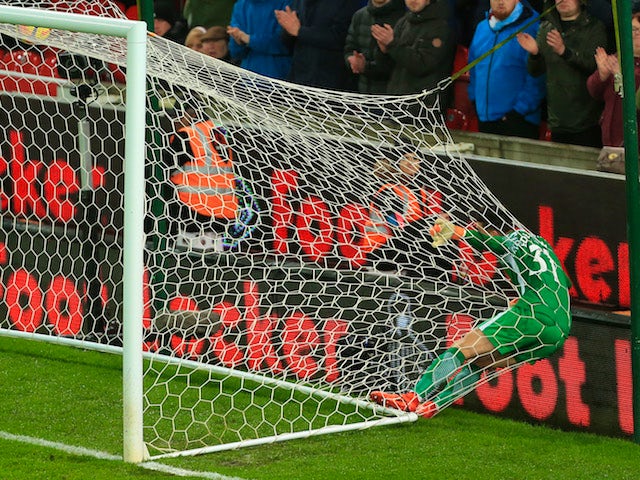 Ederson ends up in the back of the net during the Premier League game between Stoke City and Manchester City on March 12, 2018