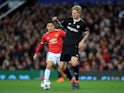 Simon Kjaer is pursued by Alexis Sanchez during the Champions League round-of-16 game between Manchester United and Sevilla on March 13, 2018