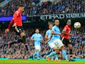 Manchester United's Chris Smalling scores against Manchester City on April 7, 2018