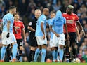 Paul Pogba argues with Fernandinho during the Premier League match between Manchester City and Manchester United on April 7, 2018