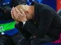 Pep Guardiola holds his head in his hands during the Champions League quarter-final game between Liverpool and Manchester City on April 4, 2018