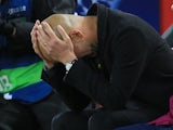 Pep Guardiola holds his head in his hands during the Champions League quarter-final game between Liverpool and Manchester City on April 4, 2018