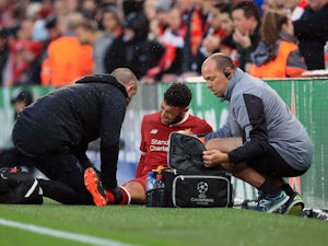 Alex Oxlade-Chamberlain sits injured during the Champions League semi-final game between Liverpool and Roma on April 24, 2018