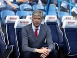 Arsene Wenger takes his seat in the dugout ahead of the Premier League game between Huddersfield Town and Arsenal on May 13, 2018