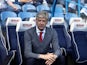 Arsene Wenger takes his seat in the dugout ahead of the Premier League game between Huddersfield Town and Arsenal on May 13, 2018
