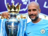Manchester City manager Pep Guardiola poses with the Premier League trophy on May 6, 2018
