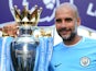 Manchester City manager Pep Guardiola poses with the Premier League trophy on May 6, 2018
