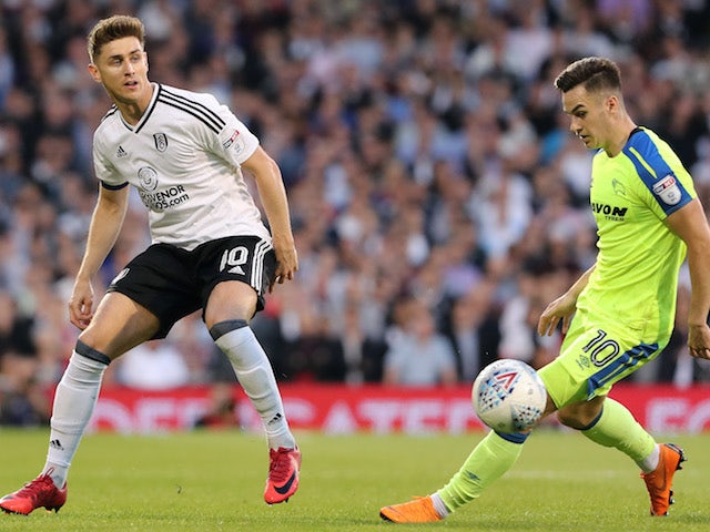 Tom Cairney and Tom Lawrence in action during the Championship playoff semi-final between Fulham and Derby County on May 14, 2018