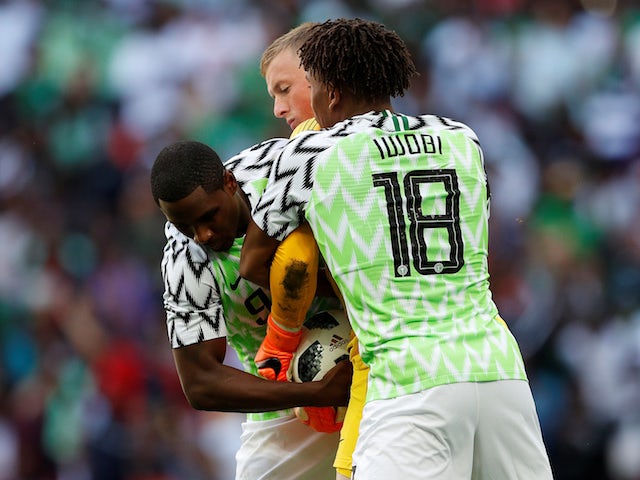 Alex Iwobi and Odion Ighalo team up to wrestle the ball from Jordan Pickford during the international friendly between England and Nigeria at Wembley on June 2, 2018