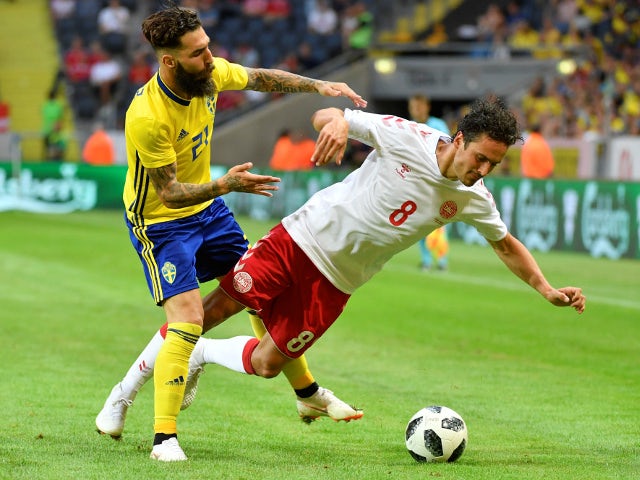 Sweden's Jimmy Durmaz brings down Denmark's Thomas Delaney during a friendly on June 2, 2018