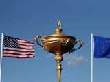 A giant version of the Ryder Cup trophy flanked by USA and European flags