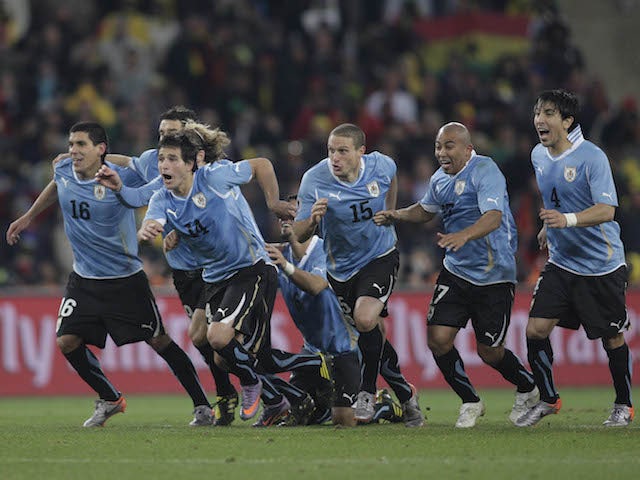 Uruguay's players celebrate their victory over Ghana on penalties in the quarter-finals of the 2010 World Cup