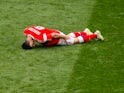Russia forward Alan Dzagoev goes down injured during his side's World Cup Group A opener against Saudi Arabia at the Luzhniki Stadium in Moscow on June 14, 2018
