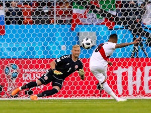 Christian Cueva misses a penalty past Kasper Schmeichel during the World Cup group game between Peru and Denmark on June 16, 2018