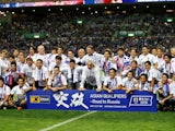 Japan's players and staff celebrate qualifying for the 2018 World Cup