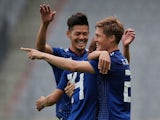 Japan players celebrate during their World Cup warm-up match against Paraguay on June 12, 2018